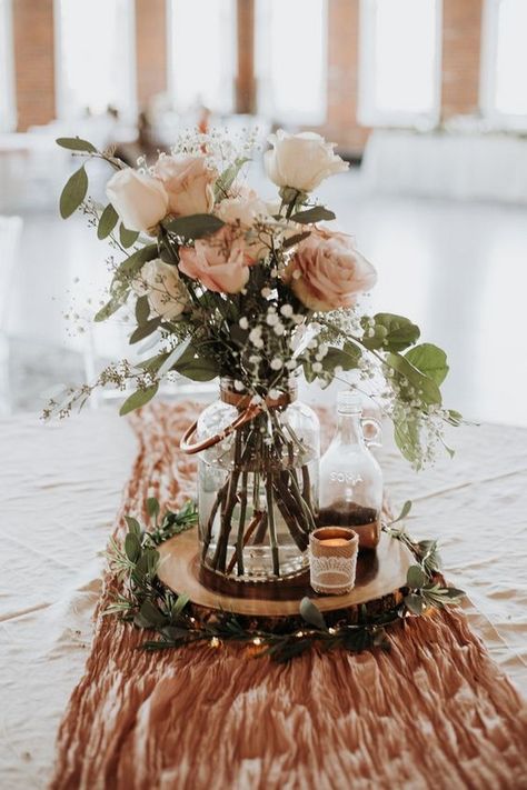 dusty rose wedding centerpiece ideas #wedding #weddings #weddingcolors #weddingideas #pinkweddings #greenweddings #hmp Rustic Vintage Party Decor, Dusty Rose Table Runner Wedding, Dusty Rose Cream Wedding, Wedding Table Centerpieces With Wood Rounds, Table Runners For Round Tables Wedding, Wood Flower Wedding Decor, Sage Table Runner Round Table, 2023 Wedding Ideas Decor, Candle And Flower Centerpieces Round Table