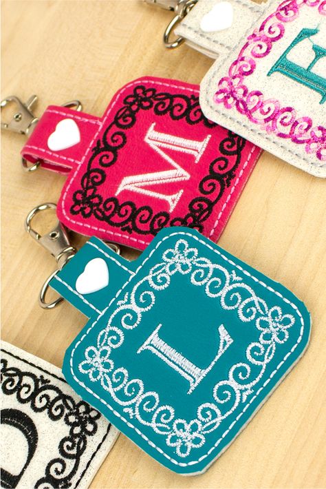 Learn how to make in-the-hoop key fobs with Designs by JuJu's Julie Trieb in our new FREE Webcast: Keepsake Key Fobs. Julie will also walk us through how to add her new Mary Kate Monogram design with or without software, how to embroider on vinyl fabric, and so much more! #DesignsByJuJu #SulkyThreads #sewbetterwithsulky #keyfobs #sewingproject Embroidered Key Fobs, Ith Embroidery Designs Free, Embroidered Keychains Diy, Making Patches, Embroidery Patches Diy, Diy Key Fob, Embroidered Keychains, Fsl Machine Embroidery, Key Fobs Diy