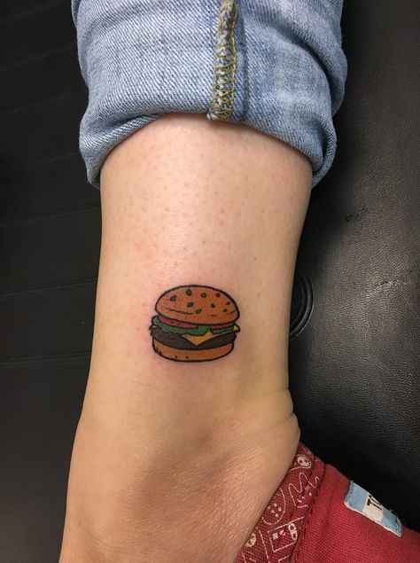 Burger tattoo by Elf Cheese Burger Tattoo, Mini Food Tattoos, Cheeseburger Tattoo Small, Bobs Burger Tattoo Ideas, Burger Tattoo Small, Small Bobs Burgers Tattoo, Bobs Burgers Tattoo Ideas, Nacho Tattoo, Small Food Tattoos