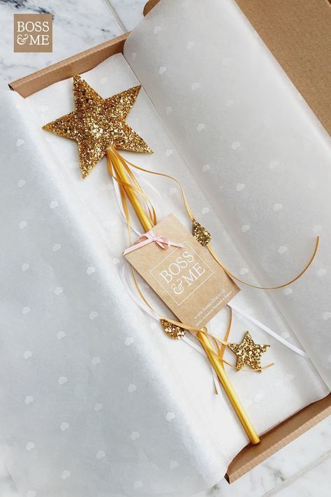 gold magic fairy wand in a box and wrapped in tissue paper. Fairy Magic Wand, Gold Magic, Birthday Fairy, Princess Wands, Magic Birthday, Magic Fairy, Star Wand, Gold Glitter Stars, Fairy Garden Birthday Party