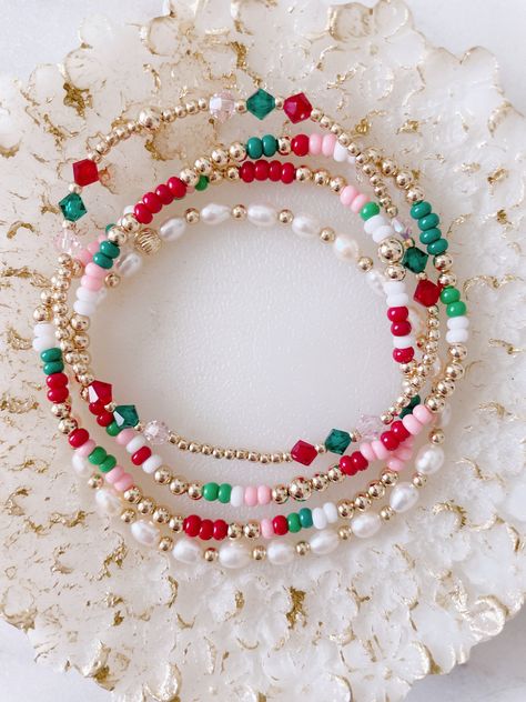 This very dainty Christmas set can be purchased as a set or individually  There are four pieces in this set. Two seed bead and gold filled beads bracelets, one pearl bracelet and Czech (three beads) and gold filled beads. Red And Gold Beaded Bracelet, Christmas Diy Bracelet, Glass Bead Bracelet Designs, Christmas Stack Bracelets, Christmas Seed Bead Jewelry, Christmas Stretch Bracelets, Preppy Christmas Bracelet Ideas, Christmas Bracelets Clay Beads, Seed Bead Christmas Bracelets