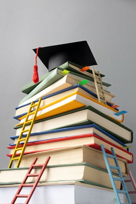 Free Photo | Low angle of stacked books, a graduation cap and ladders for education day Education Aesthetic, School Promotion, Education Day, Academic Writing Services, Stacked Books, Smart School, Youtube Banner Design, Birthday Clips, Portfolio Template Design