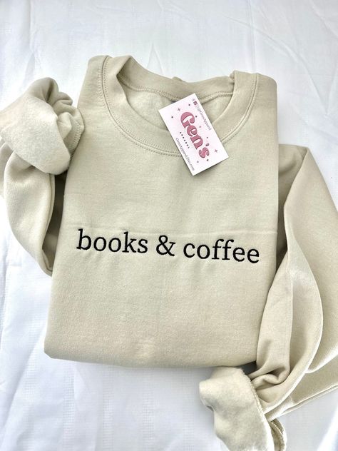 "Wrap yourself in literary comfort with our \"Books And Coffee\" embroidered sweatshirt, a must-have for every book lover in the Reading Crew. This minimalist book sweatshirt, the perfect Book Club Gift, seamlessly blends cozy warmth with bookish flair, making it an essential addition to your stylish reading ensemble. Color in example is Sand  * 50% cotton, 50% polyester * Pre-shrunk * Classic fit * 1x1 athletic rib knit collar with spandex * Air-jet spun yarn with a soft feel and reduced pillin Book Sweatshirts, Bookish Sweatshirts, Bedroom Western, Minimalist Book, Fav Products, Books And Coffee, Bookstore Cafe, Gemini And Aquarius, Bookclub Gifts