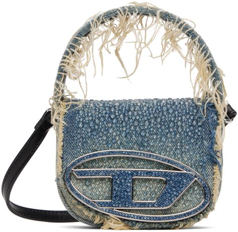 Non-stretch denim top handle bag in blue. · Fading and frayed edges throughout · Fixed carry handle · Adjustable and detachable leather shoulder strap · Crystal-cut logo hardware and detailing at face · Magnetic press-stud flap · Logo-woven twill lining · H4 x W5 x D2 Supplier color: Blue 1dr Bag, Chloe 2024, Diesel 1dr, Fits Fall, Diesel Bag, Denim Crossbody, Diesel Denim, Fancy Bags, Chanel 2