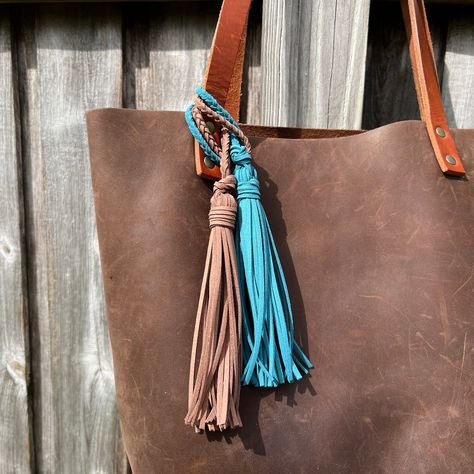 "Jazz up your tote bag, handbag or key chain with a tassel. Lariat style tassels are crafted from faux suede leather so they are stylish and cruelty free. Loop it around your bag strap, purse hardware or even your key chain for an instant update. Looped tassels are great for bags that don't have a loop to hook a clip to or when you want to use it on multiple bags with different color hardware. Each tassel is handmade, braided and knotted. Braided loop is 5\" long and each tassel is roughly 6\" l Leather Purse Charms Diy, Purse Tassels, Purse Charms Diy, Paperclip Crafts, Jewelry Pictures, Tassel Bag Charm, Tassel Purse, Purse Hardware, Free Spirit Style