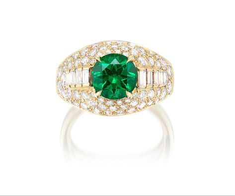 BVLGARI. An Emerald and Diamond Ring - One circular-cut emerald, 1.71 carats - Eight baguette-cut diamonds on the sides - Brilliant-cut diamond surround - Signed Bulgari - 18K gold - Ring size 7. SSEF Report: Colombia, no indications of clarity modification. AGL Report: Colombia, no gemological evidence of clarity enhancement #Bvlgari #Emerald Emerald And Diamond Ring, Baguette Cut Diamond, 18k Gold Ring, Baguette Cut, Color Ring, Ring Size 7, Cocktail Ring, Brilliant Cut Diamond, Cocktail Rings