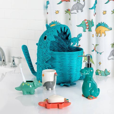 Transform your child's bathroom into a prehistoric playground with the Dinosaur 3Pc Bath Accessory Set by Allure Home Creation. The set includes a Lotion Pump with a Plastic Chrome Finish Pump Head, Toothbrush Holder and Soap Dish. Each piece is made of ceramic, creatively shaped and painted in a vibrant medley of glossy bright colors. This whimsical collection brings together a cool group of dino-mite buddies that are sure to bring fun and adventure to your little dinosaur enthusiast's bathroom Toddler Bathroom Ideas, Dinosaur Toothbrush Holder, Dinosaur Theme Room, Dinosaur Bathroom, Dinosaur Towel, Clay Dinosaur, Whimsical Nursery Decor, Dinosaur Room Decor, Toddler Boy Room Decor