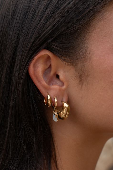 The Palma Earrings are a perfect match for anyone looking to switch up their stack. Beautifully designed to stand out from the classic square hoops, the organic shape makes these earrings art for the ears - one of a kind and timeless. 18k Gold Plated Stainless Steel Hypoallergenic, safe for sensitive ears Tarnish resistant Sold as a pair 2 Pierced Ears Ideas, Silver And Gold Mixed Earrings, How To Style Multiple Earrings, Classy Earring Stack, Chunky Earring Stack, Earring Stack Gold, Earings 2024, 3 Earrings Piercing In A Row, Earring Stacks Gold