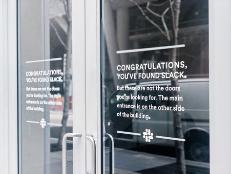 Matte white vinyl wayfinding sign with white text on glass doors for the San Francisco office of Slack, an American cloud-based set of proprietary team collaboration tools and services. Glass Door Signage, Glass Door Design, Door Signage, Team Collaboration, Wayfinding Signs, Wall Signage, Entrance Sign, Community Space, Wayfinding Signage