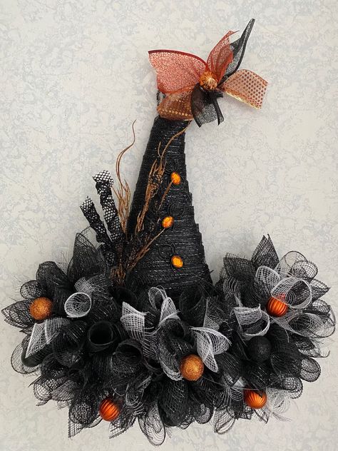 Beautiful, Black Color, 22" Mesh Wreath!! Halloween witch hat wreath with black and white deco mesh, accented with ornaments, glittery balls, spiderweb tulle, glittery curls spiders and sparkling branches because less is NOT more. Due to the handmade nature of the product, the shape, size and colors will be the same.  However the placement of the decorations will vary and the actual bling may change based on availability. Measures approximately 22"! Really full and totally whimsical. I will gladly create custom orders upon request! Just send me a message!! If you have any questions or concerns please don't hesitate to contact me The Fine Print I want you to be happy with your purchase and prefer an elated customer who will return, to a disgruntled one any day. If you have any problems or c Wreaths For Fall 2024, Mesh Witch Hat Wreath, Witch’s Hat Wreath, Black Tulle Halloween Decor, Halloween Tulle Decorations, Witch Hats Decorations, Halloween Bows Wreath, Wire Witch Hat Wreath, Grapevine Halloween Wreath