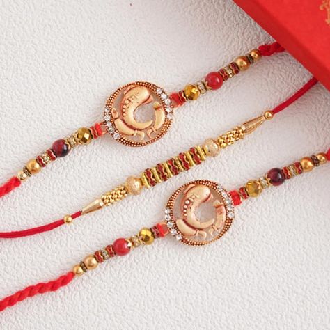 Send Splendid set of 3 divine golden Rakhi Online | Rakhibazaar.com Handmade Rakhi Designs, Rakhi Online, Black Beads Mangalsutra, Handmade Rakhi, Rakhi Design, Ganesh Statue, Silk Thread, Black Beads, Beaded Bracelets