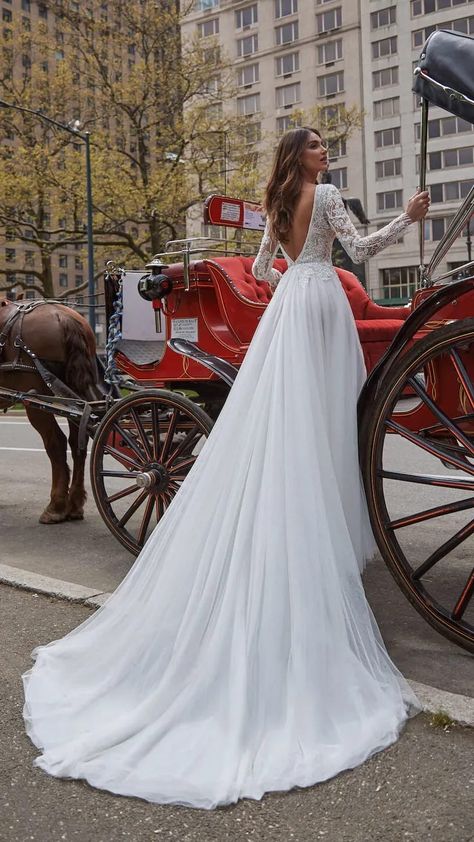 A-line Wedding dress with lace bodice and flow skirt | Bridal gown with open back, long sleeves and long train | WONÁ Concept Wedding Dresses 2022 - Style: Kim - Belle The Magazine | See more gorgeous bridal gowns by clicking on the photo Wedding Dress Cathedral Train, Elegant Long Sleeve Wedding Dresses, Wedding Dresses 2022, Wedding Dress Flowy, Long Train Wedding Dress, Lace Wedding Dress With Sleeves, Open Back Wedding Dress, Dresses 2022, Long Sleeve Wedding Dress Lace