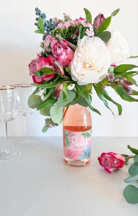 Flower Arrangements For Bridal Shower Tables, Flower Gift Ideas Diy, Champagne With Flowers, Wine Party Centerpiece Ideas, Flower Champagne Gift, Flowers On Champagne Bottle, Flowers On A Wine Bottle, Flower Bouquet On Wine Bottle, Wine Bottle Flower Centerpiece