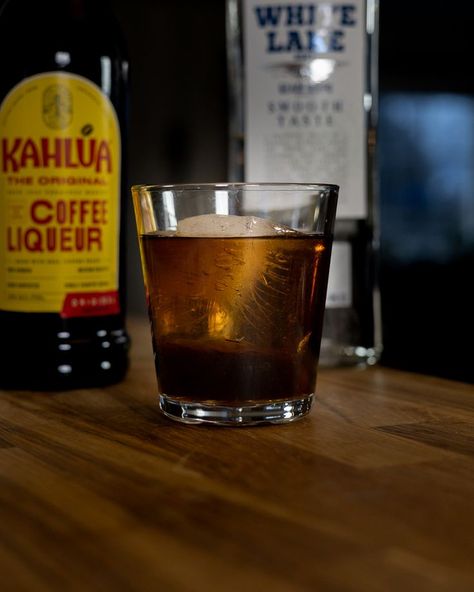 The Black Russian is a simple cocktail that combines vodka with Kahlua (a coffee liqueur made from rum, sugar, and arabica coffee). Gustave Tops, a bartender at the Hotel Metropole in Brussels, created the drink in the late 1940s. According to the legend, the drink was made for Perle Mesta! An American ambassador. The name refers to the ingredients. Kahlua, which is black, and vodka that is often associated with Russia. (Ignore the fact that Kahlua can be made in Mexico. Coffee And Vodka, Liqueur Cocktails, Simple Cocktail, Coffee Liqueur, Black Russian, White Lake, Vodka Cocktails, Easy Cocktails, Arabica Coffee