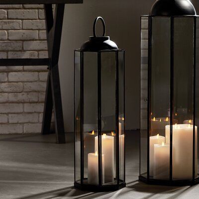 Standing at over tall, the turino lantern is all about drama. a stunning focal point. | Longshore Tides Iron Floor Lantern black/gray 27.25 x 8.5 x 8.5 in | C004147251_487469334 | Wayfair Canada Lantern Fireplace Decor, Floor Lanterns, Rustic Cottage Style, Floor Lantern, Glass Candle Lantern, Floor Candle Holders, Kitchen Island Decor, College Apartment Decor, Lower Deck