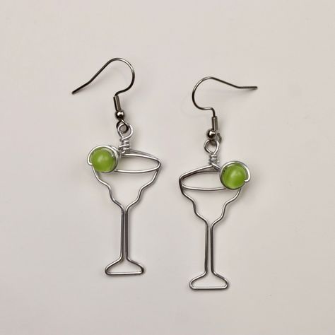 Margarita Glass Earrings. Great gift for Bartenders, Hostesses and Waitresses. Aluminum wire will not tarnish. The bead represents the lime and is a 6mm cat's eye bead. See the inset for the option for a green wire spiral, green wire spiral with a 4mm Miracle bead or a fancy glass bead.  Surgical steel hooks are hypo-allergenic. Clear plastic stoppers on backs. I have been making custom wire art and jewelry for 30 years. I started in 1989 selling jewelry on the streets of Montreal. Over the year Margarita Earrings, Diy Earrings Dangle, Plastic Stoppers, Wire Spiral, Creative Jewelry Photography, Custom Wedding Cake Toppers, Earrings Wire, Sports Figures, Of Montreal