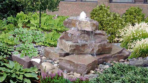 Build a stacked stone water feature: easy steps Stacked Stone Fountain Diy, Diy Rock Fountain Stacked Stones, Stacked Stone Water Fountain, Flagstone Fountain Diy, Sandstone Water Feature, Backyard Waterfalls Diy, Diy Disappearing Water Fountain, Stacked Stone Waterfall, Stone Fountain Garden