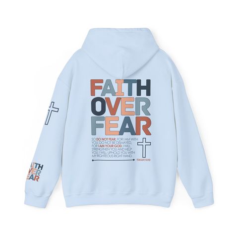 Faith Over Fear Hoodie: Embrace Courage in Every Step Confront the challenges of life with unwavering faith wearing our Faith Over Fear Hoodie, adorned with the empowering words of Isaiah 41:10. Crafted from a premium hoodie, this garment becomes a symbol of courage, a reminder that faith has the power to overcome fear. Whether you're seeking warmth or making a bold statement, this hoodie wraps you in comfort and a message of strength, inspiring you to face every day with faith prevailing over fear. Key Features: Empowering Verse: Isaiah 41:10 elegantly displayed, transforming your hoodie into a wearable source of courage and inspiration. Premium Comfort: Revel in the softness and coziness of our hoodie, providing a warm embrace on cooler days. Bold Design: A powerful yet simple design tha Symbol Of Courage, Jesus Clothes, Christian Shirts Designs, Unwavering Faith, Overcome Fear, Christian Hoodies, Empowering Words, Christian Bible Quotes, Christian Sweatshirt