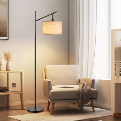 This arched floor lamp showcases a minimal design and a mix of materials, making it a versatile addition to your modern decor. Crafted from iron, the round base and arm provide a solid foundation. The beige linen drum shade casts a warm, ambient glow, ideal for shining some light over a reading corner or your sofa while you watch TV. Plus, its convenient foot switch makes it easy to turn on and off without bending down or stooping over. Place this floor lamp in your living room or bedroom to enh Floor Lamp Corner Sofa, Floor Lamp Modern Living Room, Floor Reading Lamps Living Room, Floor Lamp Small Living Room, Chair And Lamp In Corner, Reading Corner For Bedroom, Lamp In Corner Living Room, Read Corner Living Room, Zen Corner Living Room