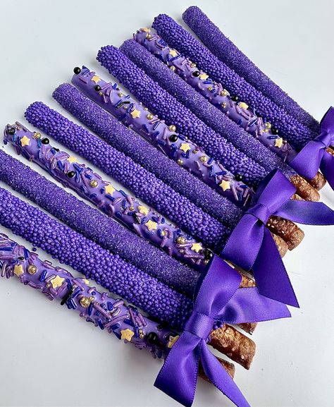 This listing is for 12 pretty purple pretzels. Each fresh pretzel rod is dipped in creamy purple chocolate and decorated with 3 different sprinkles: purple sugar, purple nonpareils and purple jimmies with gold stars. A perfect addition to a dessert table, a birthday party or shower. So beautiful that all the guests will want one.  Each favor will arrive to you individually wrapped in a clear cellophane sleeve and tied with color coordinating ribbons.  Delightful Chocolates cannot be held responsible for melted chocolate once the package has left our facility. We take great pride in insulating our boxes and packaging with ice sheets if needed PLEASE PURCHASE ICE SHEETS IF YOU LIVE IN A WARM CLIMATE. WE WILL NOT SHIP IF YOU ARE IN TEMPERATURES OF 65 DEGREES OR ABOVE  These confections were c Purple Birthday Party Snacks, Purple Themed Snack Board, Purple Party Favors Ideas, All Purple Birthday Party, Purple Themed Food Board, Purple Adult Birthday Party, Purple And Blue Party Decorations, Purple Chocolate Covered Pretzels, Witchy Snacks