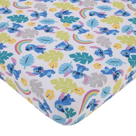 The Disney Stitch Fitted Crib Sheet is designed in a cute allover pattern with smiling Stitch, tropical palm trees, hibiscus flowers, and colorful rainbows, and palm leaves. Featured in shades of blue, lime, aqua, pink, coral, and white. Measures 28" x 52" x 8" and fits a standard size crib/toddler mattress. Includes full elastic for a safe and snug fit. Coordinates with the Disney Stitch Infant Bedding! Stitch Theme Nursery, Lilo And Stitch Room, Stitch Bedspread, Stitch Room, Stitch Nursery, Teal Nursery, Stitch Blue, Tropical Palm Trees, Tropical Nursery