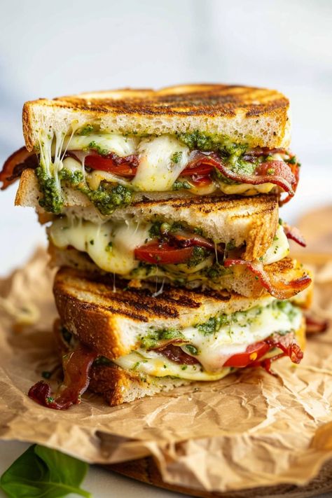 This pesto grilled cheese sandwich is a fun twist on an American classic. And it's so tasty, you might never make regular grilled cheese again! Grilled Cheese With Arugula, Grilled Ricotta Cheese Sandwich, Grilled Cheese With Meat Recipes, Turkey Bacon Grilled Cheese, Balsamic Grilled Cheese, Margarita Grilled Cheese, Grilled Cheese On The Grill, Delicious Grilled Cheese, Bruschetta Grilled Cheese