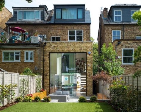 Large double height glass doors to the rear of this house renovation. The doors have a slim 21mm sightline and stand at 21mm. Even at this size they are still manually operated with a smooth sliding action. Glass Balcony, London Townhouse, Three Bedroom House, House Extension Design, Rear Extension, Victorian Terrace, Kitchen Extension, Loft Conversion, Balcony Design