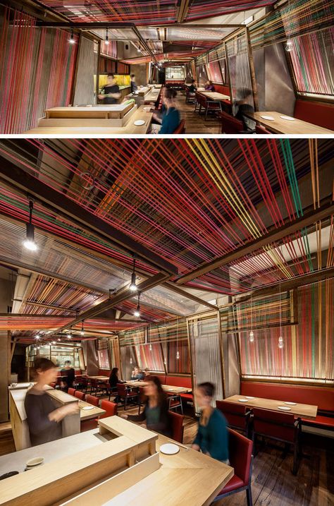 El Equipo Creativo have designed the Pakta Restaurant in Barcelona, Spain, that features an interior with brightly colored ropes. #InteriorDesign #RestaurantDesign #Rope #Ceiling Restaurants Ceiling Design, Ceiling Design Restaurant, Bar Ceiling Design, Lines Interior Design, Rustic Restaurant Interior, Colorful Ceiling, Rope Ceiling, Mexican Restaurant Decor, Restaurant Ceiling