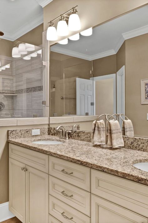 Warm earth-toned primary ensuite bathroom with cream cabinets and granite vanity top. Cream Bathroom Cabinets, Cream Bathroom Ideas, Primary Ensuite, Cream Colored Cabinets, Kure Beach Nc, Heated Tile Floor, Mini Bathroom, Cream Bathroom, Cream Cabinets