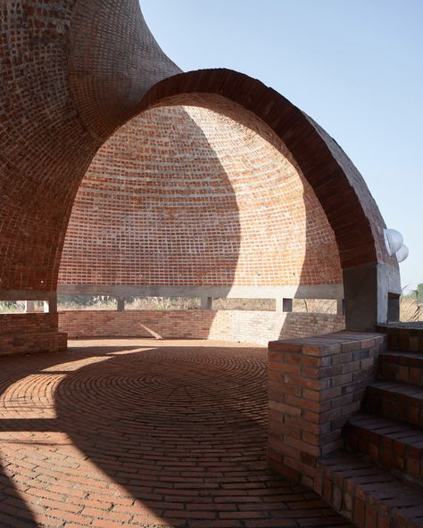 The pavilion by HCCH Studio is enclosed by a shell-like structure. Shell Structure Architecture, Brick Library, Shell Structure, Library Pictures, Brick Construction, Spiral Shell, Library Architecture, Brick Architecture, Famous Architects