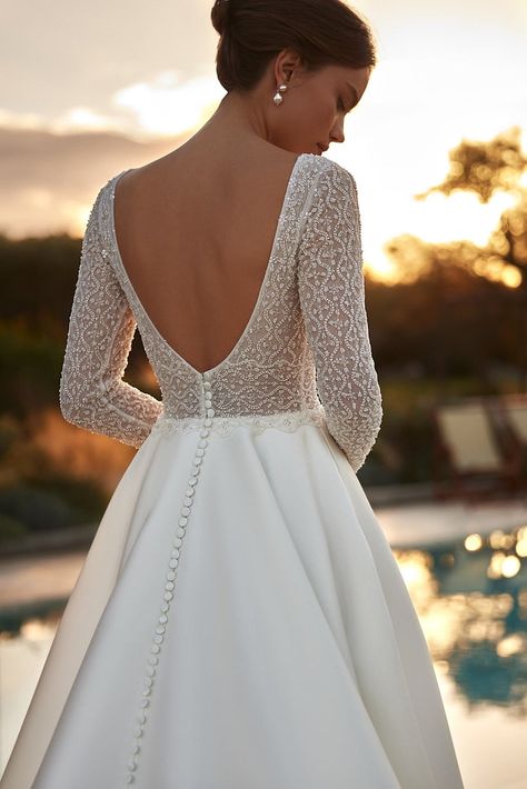 Experience the epitome of bridal elegance with our modern long sleeve wedding gown. Crafted to exude sophistication and grace, this dress features an intricately beaded corset that highlights your waist with stunning finesse. The luxurious lace sleeves and deep V-back are designed to reveal just the right amount of ski Elegant Long Sleeve Wedding Dresses, Long Sleeve Wedding Gown, Corset Plus Size, Custom Design Dress, Beaded Corset, Long Bridal Gown, Long Sleeve Wedding Gowns, Classic Bride, Timeless Wedding Dress