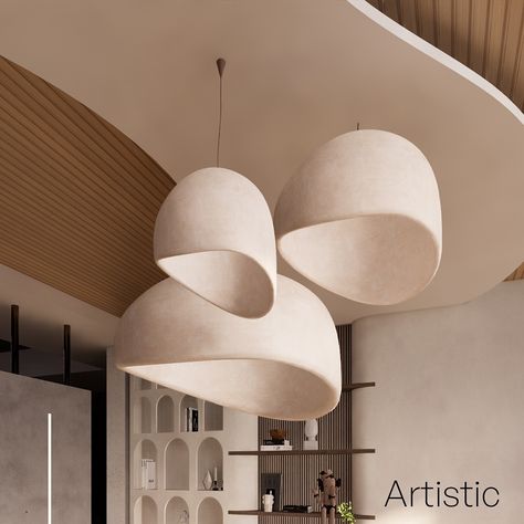 This elegant and modern lighting design features a cluster of three sculptural pendant lights, gracefully suspended from the ceiling. Their organic, asymmetrical shapes create a sense of fluidity and movement, blending seamlessly with the contemporary interior. The warm, neutral tones of the lampshades complement the natural wooden elements of the ceiling and wall panels, creating a harmonious and inviting atmosphere. The backdrop showcases open shelving with curated decor pieces, adding a to... Organic Lighting, Asymmetrical Shapes, Curated Decor, Modern Lighting Design, Stylish Interior, Decor Pieces, The Ceiling, Wall Panels, Neutral Tones