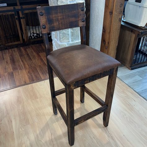 Our Ponderosa Barstool, crafted from premium quality textured pine wood. This barstool cushion is designed to provide a comfortable seating experience while adding a touch of rustic charm to your home decor. The cushion is expertly crafted to ensure durability and longevity, making it a perfect addition to any bar or kitchen counter. The textured pine wood finish adds a unique and natural aesthetic to the cushion, making it a standout piece in any setting. The cushion is easy to clean and mainta Rustic Island Chairs, Western Bar Stools Rustic Furniture, Rustic Kitchen Bar Stools, Cabin Bar Stools, Cushioned Bar Stools, Rustic Bar Stools With Back, Western Style Furniture, Barstools In Kitchen With Backs, Comfortable Bar Stools Kitchen Island