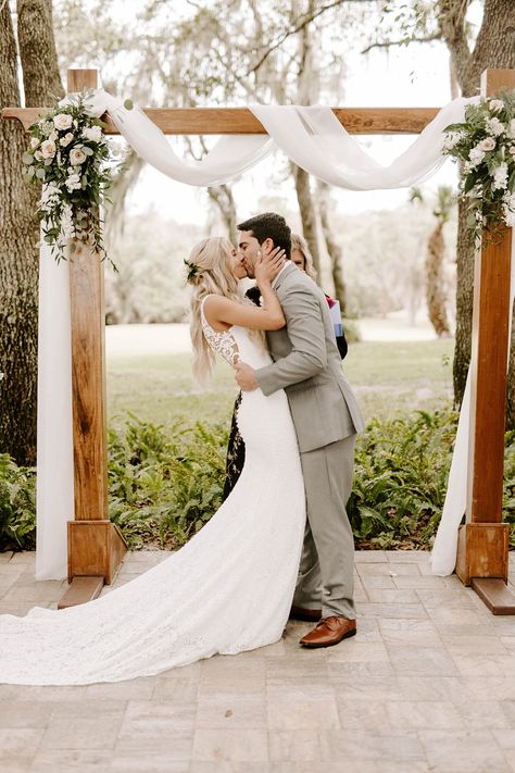 This couple wow'ed the crowd at this simple and elegant outdoor ceremony. Boho Greenery Wedding Arch, Simple Boho Wedding Arbor, Simple Floral Wedding Ceremony, Green Wedding Arch Outdoor Ceremony, Elegant Wedding Ceremony Outdoor, Simple Wedding Arbor Ideas, Simple Wedding Arches Outdoors, Wedding Arbor Simple, Wedding Trellis Ideas Arches