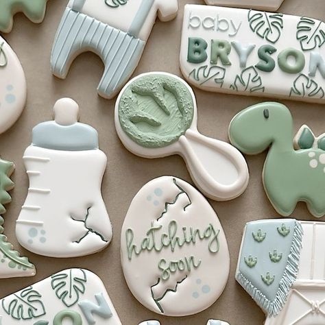 Nicole Phelps on Instagram: "Baby Bryson hatching soon! 🐣🦖 . . . . . . . . . . . . . . . . . . . . . . #sandiegocookies #cookiesofinstagram #cookies #sandiegobakersclub #sandiego #babyshowercookies #yum #cookiedecorating #babyshower #sweet #cookieart #food #dinosaurcookies #partyideas #partyplanner #foodart #cookie #cookiedecorating #foodnetwork #instagood #customcookies #cute #love #thebump #like #dinosaurbabyshower #party #photooftheday #sugarcookies" Hatching Soon Cookies, Gender Neutral Dinosaur Party, Dragon Baby Shower Cookies, Ready To Hatch Baby Shower Ideas, Hatching Soon Dinosaur Baby Shower Ideas, Dino Gender Reveal, Dinosaur Theme Baby Shower Ideas, Dino Baby Shower Cake, Hatching Soon Baby Shower Ideas