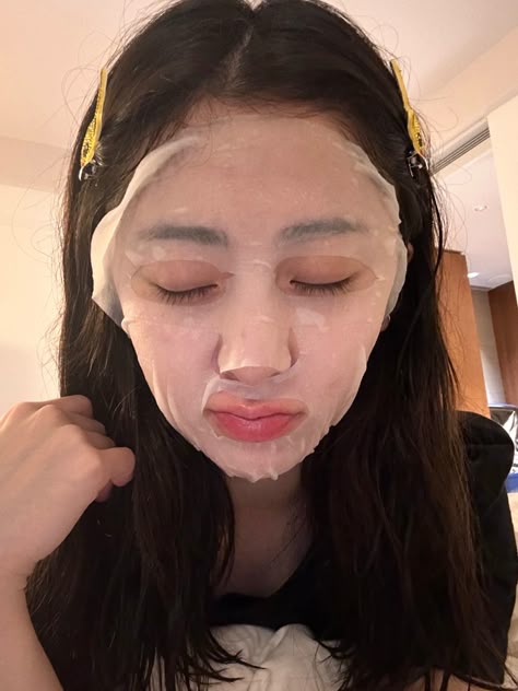 a woman with her face covered in white paper