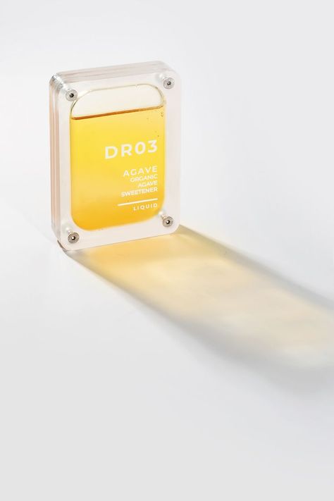 Creative perfume packaging with transparent bottle and yellow ingredient. Creative Perfume Packaging, Transparent Bottle, Cosmetic Package, Cosmetic Packaging Design, Perfume Packaging, Beautiful Branding, Coffee Packaging, Perfume Brands, Creative Packaging