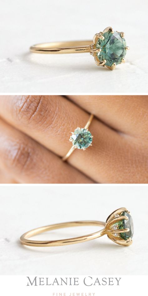 A green Montana sapphire engagement ring, featuring a 1.35ct. center stone on a delicate 14k yellow gold band, accented by scattered diamonds set among the prongs. See this one-of-a-kind piece at melaniecasey.com. Gold Band Sapphire Engagement Ring, Diamond And Emerald Engagement Ring Gold, Dainty Green Engagement Ring, Gold Band Green Stone Engagement Ring, Natural Gemstone Engagement Rings, Simple Green Engagement Rings, Engagement Ring Green Stone, Engagement Ring Not Diamond, Green Montana Sapphire Engagement Ring