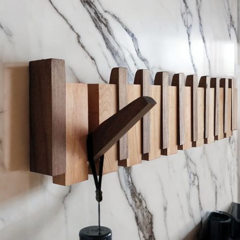 Introducing our Natural Wood Wall Mounted Piano Coat Rack! 🎹🧥 Crafted with natural wood and handmade with care, our coat rack features a unique flip-up design to keep the hooks neatly tucked away when not in use. Plus, thanks to the wooden piano keys being attached with magnets, you can rest assured that they won't fall down unexpectedly. 🌟 Available in three hardwood options to complement any decor, these entryway storage racks are versatile and practical. Whether you need a place to hang yo Piano Coat Rack, Wooden Piano, Diy Coat Rack, Wall Hook Rack, Wood Hooks, Piano Key, Storage Racks, Entryway Storage, Hook Rack