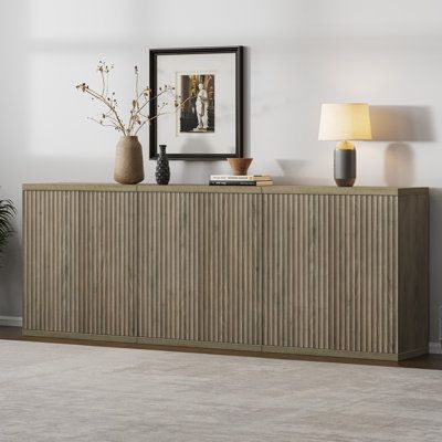 This buffet cabinet is a modern and stylish addition to your home. It combines functionality and aesthetics seamlessly. With storage compartments, doors, and shelves, it offers ample space to organize your items. The fluted design adds a touch of elegance, making it a standout piece. Crafted from wood, it exudes a mid-century charm and can serve as a credenza in the living room, a sideboard in the kitchen, or a coffee bar table in the dining room or hallway. Its versatile design makes it suitabl Dining Room Sideboard Ideas Modern, Dining Table And Sideboard, Coffee Bar Table, Dining Room Credenza, Dining Room Buffet, Buffet Cabinet, Sideboard Furniture, Accent Cabinet, Adjustable Shelves