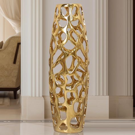 PRICES MAY VARY. Lustrous Golden Ceramic Vase: This exquisite ceramic vase features a hollow glossy finish, capturing the essence of sophistication. Crafted meticulously from porcelain, it showcases a shimmering golden hue that adds a touch of opulence to any space. Handcrafted Hollow Pattern: The ceramic vase boasts a meticulously handcrafted hollow pattern, displaying intricate craftsmanship. Each detail reflects artistic finesse, making it a fabulous piece that blends classic elegance with co Gold Vase Greenery, White And Gold Christmas Living Room, Living Room Decor Black And Gold, Large Floor Vase Decor, Tall Vase Decorating Ideas, Tall Floor Vase Ideas, White And Gold Home Decor, Gold Decor Accents, Oversized Floor Vases