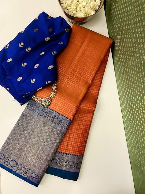 Orange and royal blue korvai kanchipuram silk saree with shorter border on top and longer border at the bottom, bright and chirpy, retro colour combo, checked body and multi design border Traditional Silk Saree Look, Blue And Orange Saree, Kanchipuram Silk Saree Wedding Latest, Orange Silk Saree, Kancheepuram Silk Saree, Royal Blue Saree, Saree Color Combinations, Latest Silk Sarees, Saree Styling