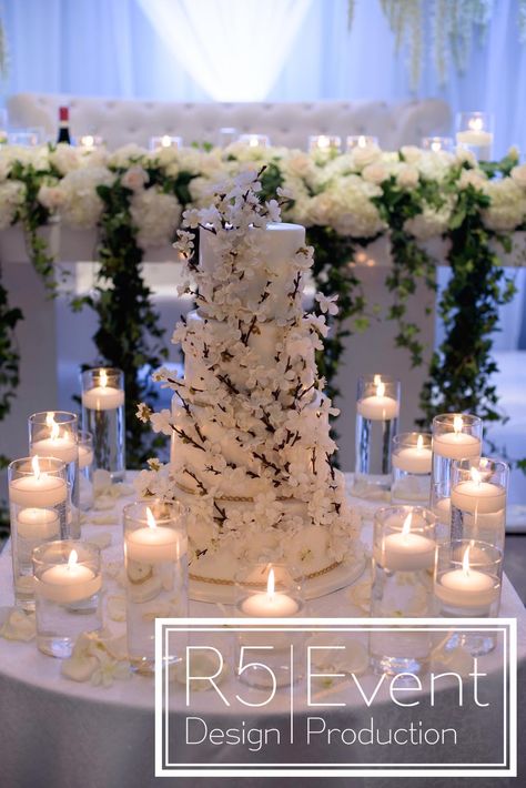 Beautiful cake table with floating candles, in front of the Sweetheart Table! Full service event decor by R5 Event Design.Cake by Casa Dolce Wedding Cake Tables Ideas Elegant, Wedding Cake Table With Candles, Cake Table With Candles, Ivory Wedding Decor, Brides Table, Floating Candles Wedding, 16 Candles, Cake Tables, Red Wedding Theme