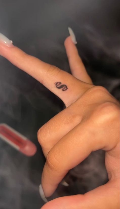 Dollar tattoo,tattoo,finger tattoo Hand Tats Small, Money Sight Tattoo, Dollar Sign Tattoo On Finger, Money Sign Tattoo On Finger, Coin Size Tattoo, Dollar Sign Finger Tattoo, Arabic Tattoo With Butterfly, Red Dollar Sign Tattoo, Small Hand Tats For Women