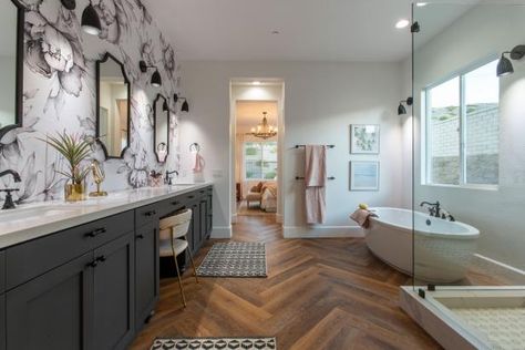 Oversized floral wallpaper brings movement and pattern to this warm, inviting bathroom designed by Mina Starsiak Hawk of Rock the Block. Rustic herringbone wood floors and a dark gray vanity add depth and warmth to the space, while a polished soaker tub brings in a note of contemporary style. The Block Bathroom, Mina Starsiak, Alison Victoria, Rock The Block, Jasmine Roth, Hgtv Designers, Victoria House, Bathroom Makeovers, Herringbone Wood Floor