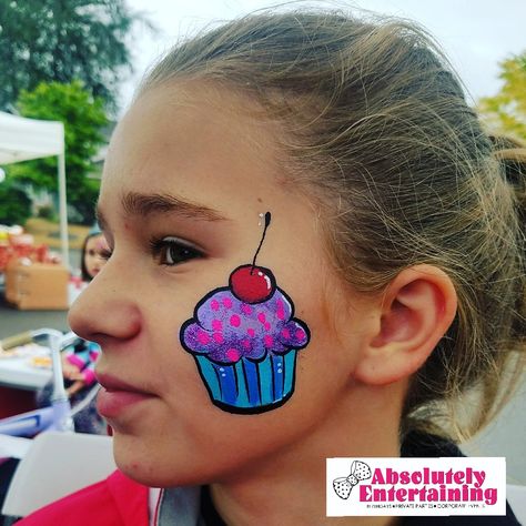 Cupcake face paint, cheek art f @absolutelyentertaining #lisaglabe Face Painting Cheek Art, Cheek Art Face Paint, Cupcake Face Paint, Candy Face Painting, Small Face Painting Ideas Cheek Art, Summer Face Paint Ideas, Face Paint Cheek Art, Basic Face Paint, Easy Face Painting Ideas For Kids Simple Cheek Art