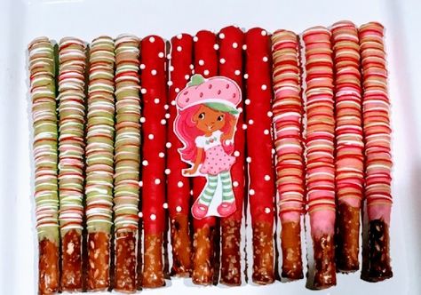 Strawberry Themed Pretzel Rods, Strawberry Shortcake Pretzels, Strawberry Shortcake Party Food, Strawberry Shortcake Theme 1st Birthday, Strawberry Shortcake First Birthday Theme, Strawberry Shortcake Theme Party Treats, Strawberry Shortcake Bday Theme, Strawberry Theme Dessert Table, Strawberry Birthday Desserts