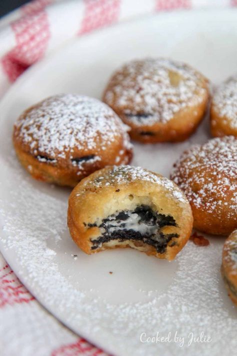 deep fried Oreos with powdered sugar on a white plate with one half eaten cookie and a red and white towel on the side. Fry Oreos Recipes, Deep Fried Finger Foods, Cooked By Julie, Deep Fried Oreos In Air Fryer, How To Make Fried Oreos, Baked Oreos, Fried Oreo Recipe, Air Fried Oreos, Fried Oreos Recipe