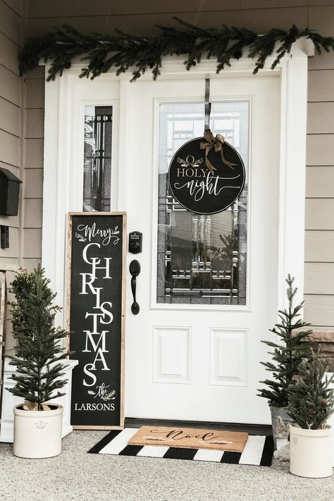 A Simple & Rustic Farmhouse Christmas Front Porch - Cream and Black Winter decor, faux green Christmas trees, farmhouse wood signs, and simple garland - Rain and Pine Farmhouse Christmas Front Porch, Christmas Cream, Rustic Farmhouse Christmas, Cream Decor, Christmas Decor Inspiration, Christmas Front Porch, Christmas Porch Decor, Farmhouse Front, Christmas Decorations For The Home