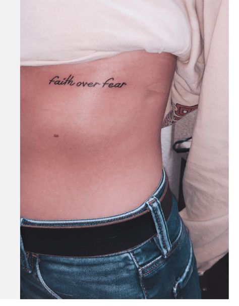 Faith Over Fear Rib Tattoo, Christian Rib Tattoos For Women, Faith Over Fear Tattoo For Women, Faith Over Fear Tattoo, Tattoo On Ribs, Fear Tattoo, Tattoo Ribs, Minimalist Tattoo Meaning, Tattoo Over Scar